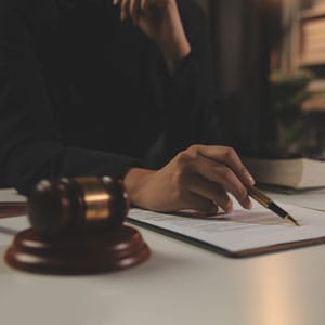 Lawyer reviewing documents during initial consultation.